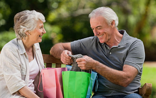 Active Aging Couple Looking at a Present